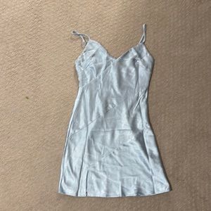 Blue mini dress with a satin material. Mini slit on side, a-symmetrical lines